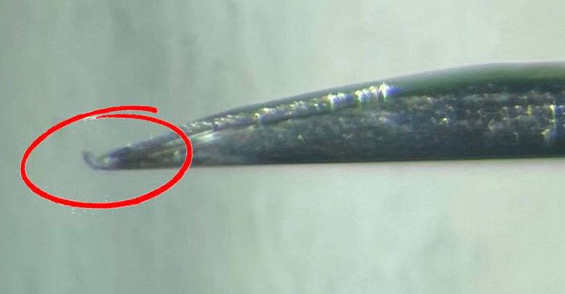 Close-up of the 30-gauge needle tip with a slightly bent hook created for corneal suture removal